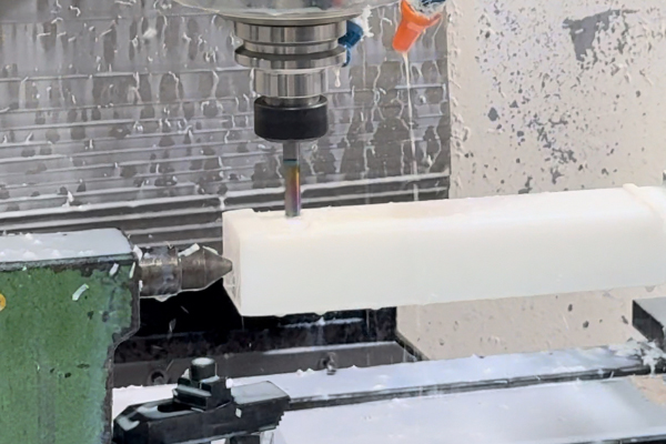 Milling a plastic block with coolant, workshop photograph from the company website.