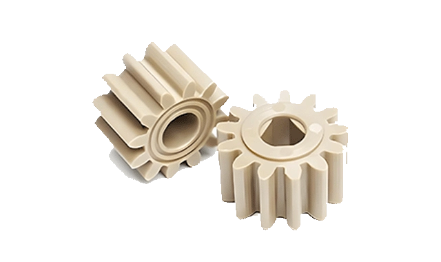 Light-coloured PEEK gears, titled as PEEK material on the source page.